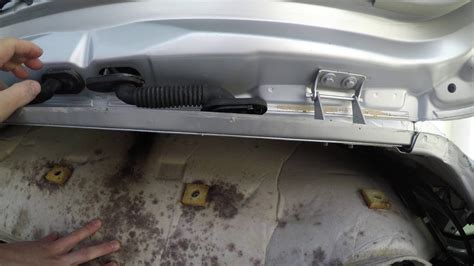 I was told the cure was to remove the 2 black grommets , one either side when you open the tailgate , silicon sealant in the holes and replace the grommets. . Ford focus water leak boot